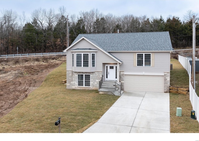 bi-level home with a garage and a front yard