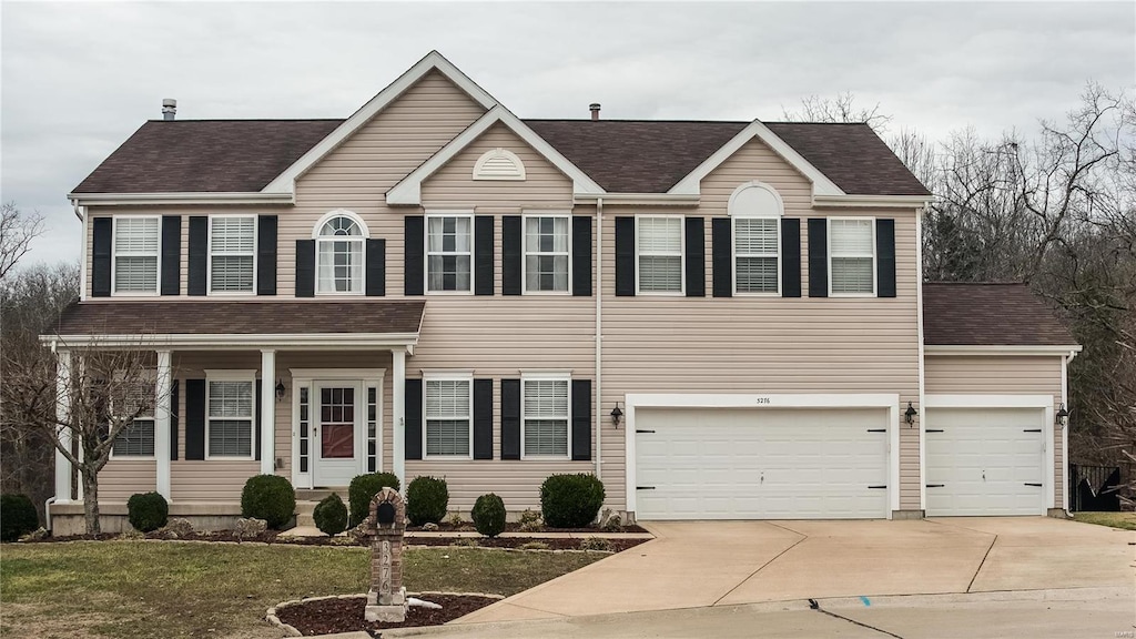 view of front of house featuring a garage and a front lawn