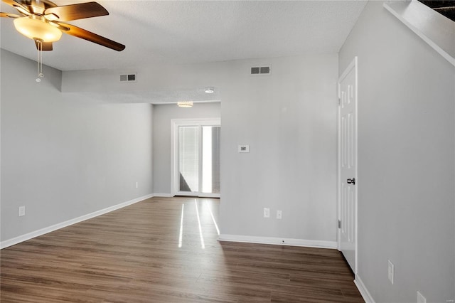 spare room featuring ceiling fan, dark hardwood / wood-style flooring, and a textured ceiling