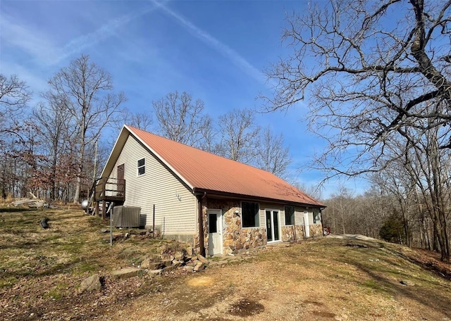 view of side of home with central air condition unit