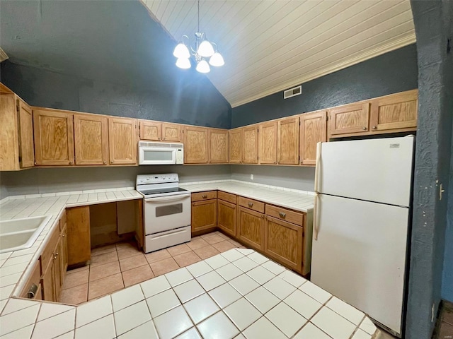 kitchen with light tile patterned floors, white appliances, vaulted ceiling, hanging light fixtures, and tile countertops