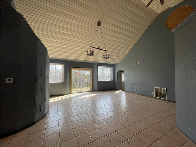 tiled foyer entrance featuring a notable chandelier, wood ceiling, and high vaulted ceiling