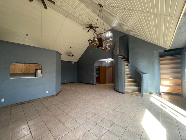 unfurnished living room featuring light tile patterned flooring, ceiling fan, and high vaulted ceiling