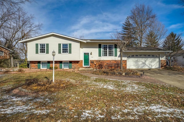 bi-level home featuring a garage and a yard