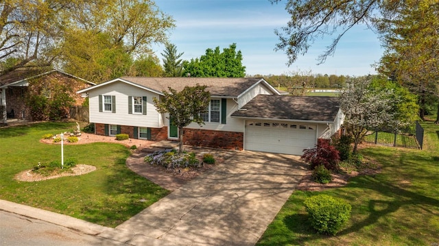 raised ranch featuring concrete driveway, fence, brick siding, an attached garage, and a front yard