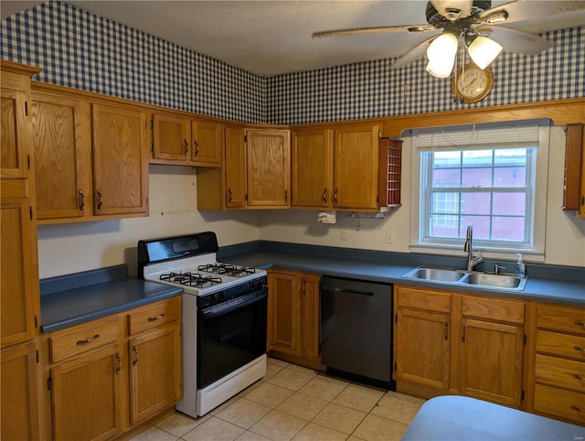 kitchen with black dishwasher, sink, light tile patterned floors, ceiling fan, and gas range oven