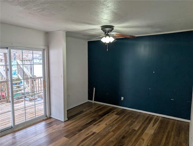 spare room with ceiling fan, a textured ceiling, and dark hardwood / wood-style flooring