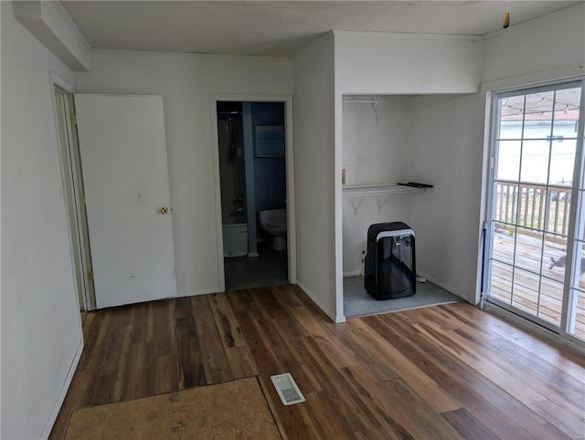 unfurnished living room featuring dark wood-type flooring