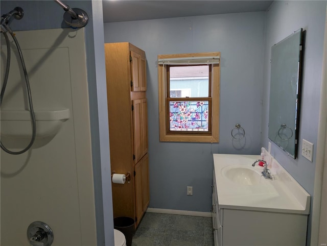 bathroom with vanity and a shower