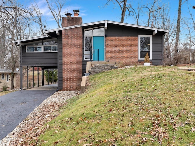 view of property exterior with a carport and a yard