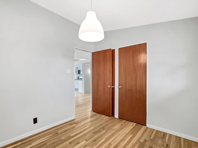 spare room with light wood-type flooring