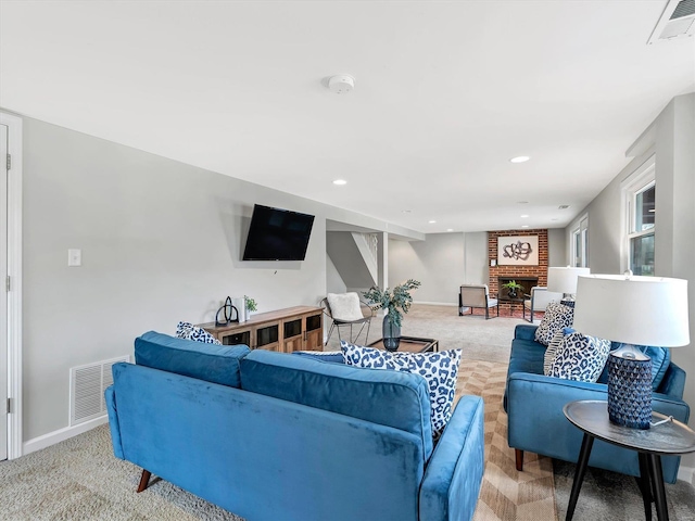 living room featuring a fireplace and light colored carpet