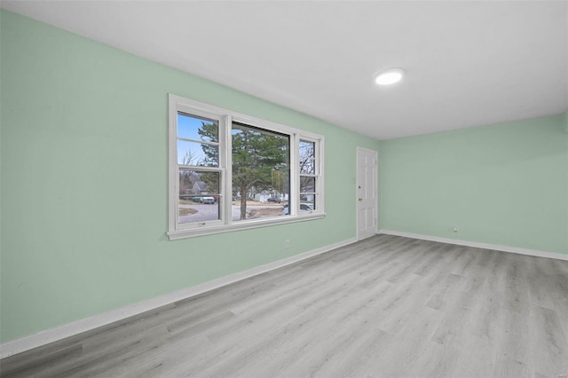 empty room with light hardwood / wood-style flooring