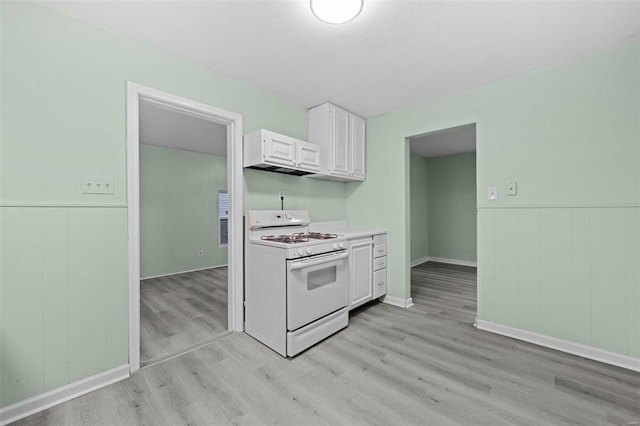 kitchen featuring white gas range, white cabinets, and light wood-type flooring