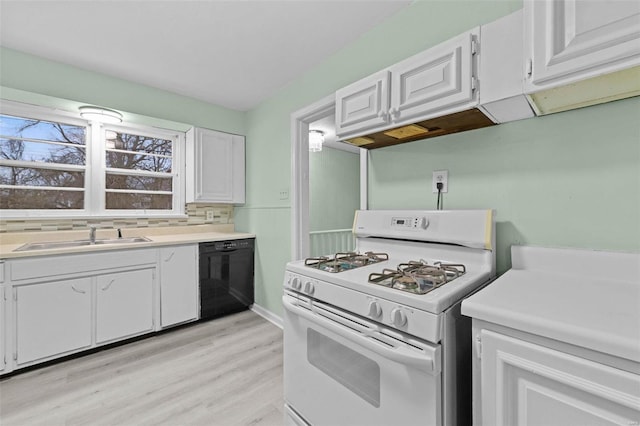 kitchen featuring white cabinetry, black dishwasher, sink, white gas range oven, and light hardwood / wood-style flooring