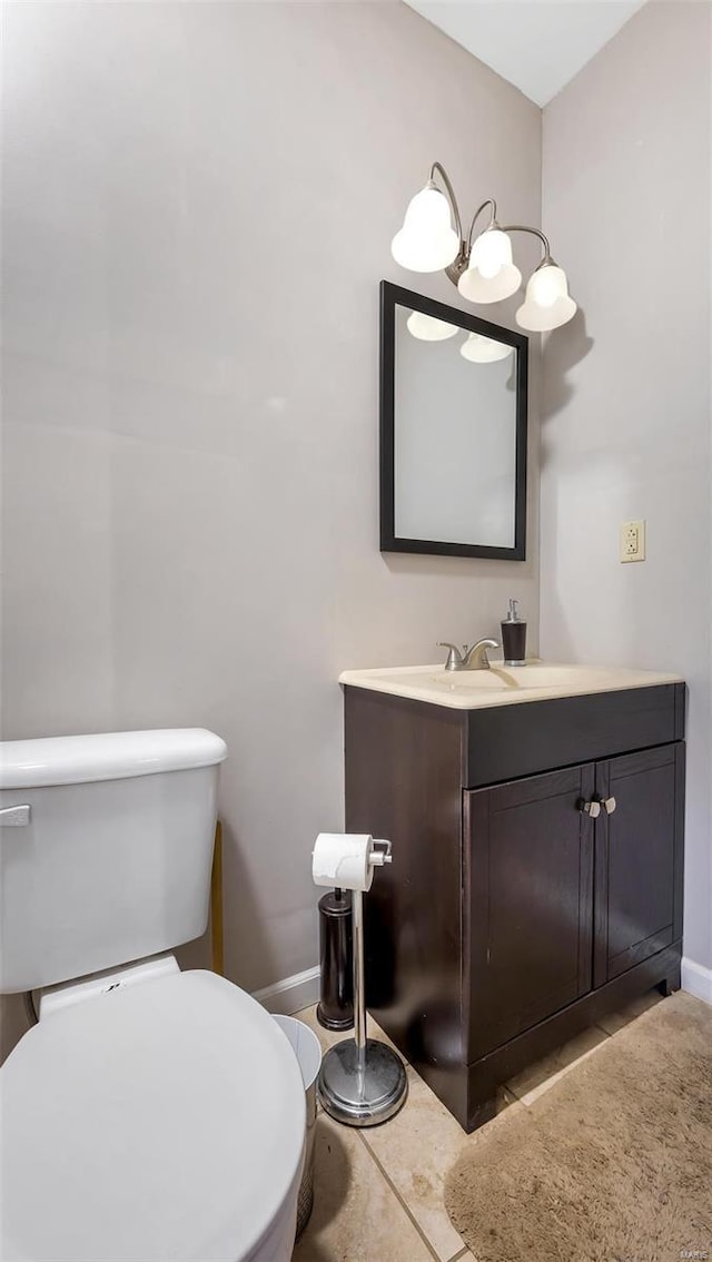 bathroom featuring tile patterned flooring, vanity, and toilet