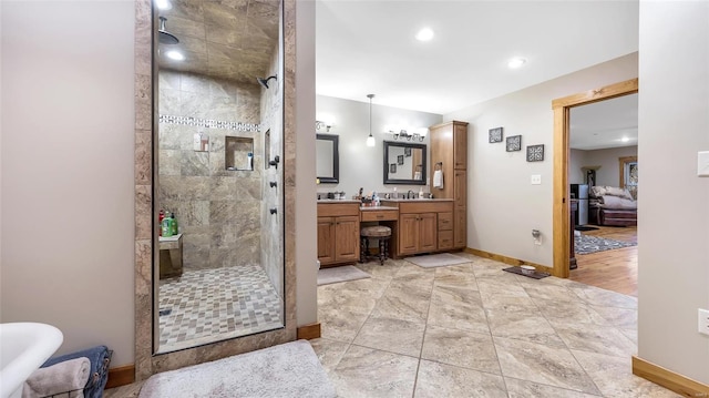 bathroom featuring vanity and a shower with door