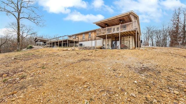 back of house featuring a wooden deck