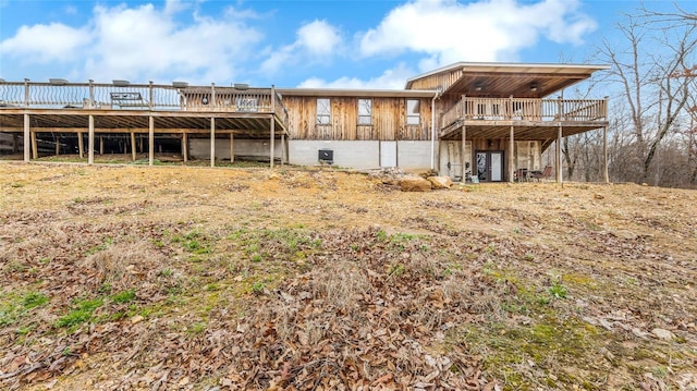 back of house featuring a wooden deck