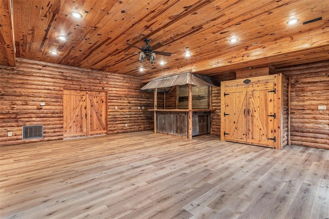 interior space with ceiling fan, log walls, wood ceiling, and light hardwood / wood-style flooring