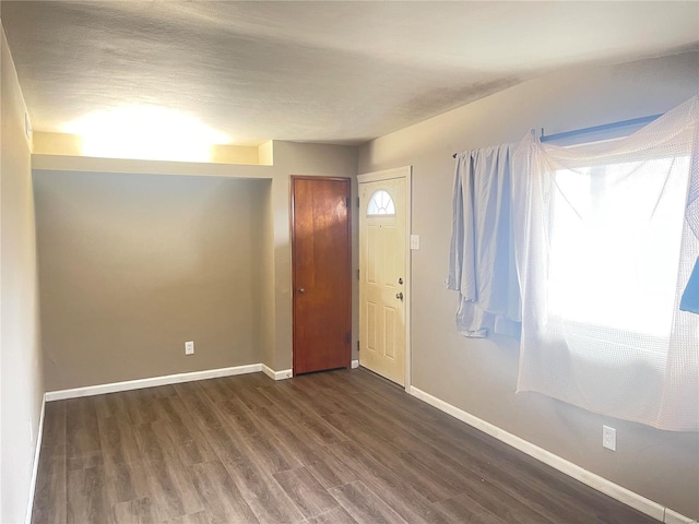 entryway with a textured ceiling and dark hardwood / wood-style flooring