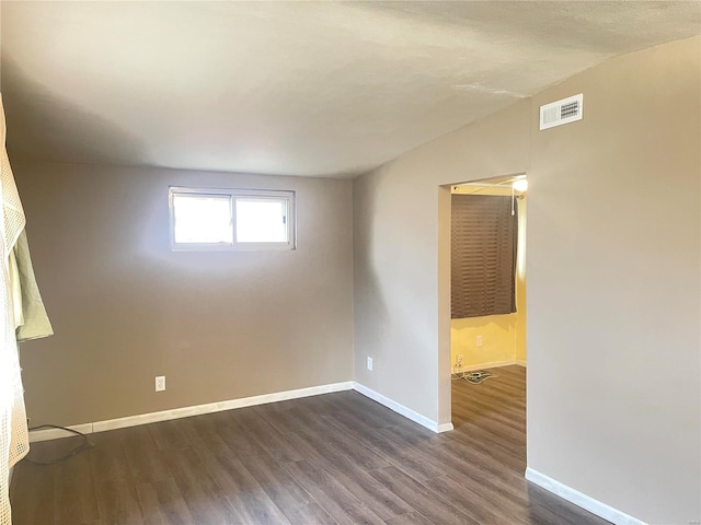 spare room featuring dark hardwood / wood-style floors