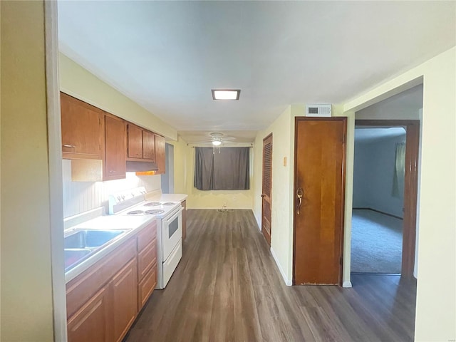 kitchen with electric stove, ceiling fan, dark hardwood / wood-style floors, and sink