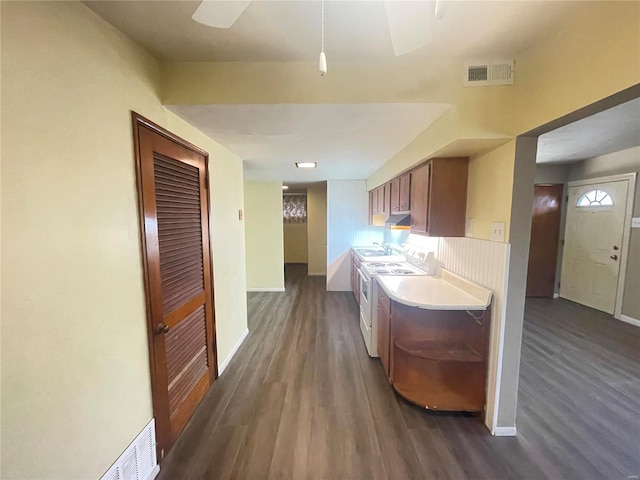 kitchen featuring washer / dryer and dark wood-type flooring