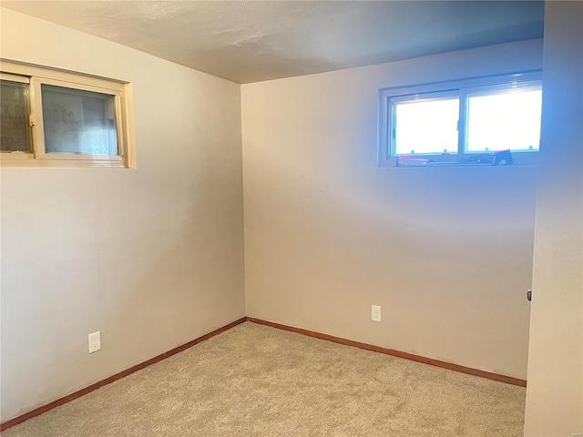 spare room featuring light colored carpet