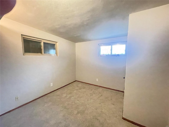 basement featuring light carpet