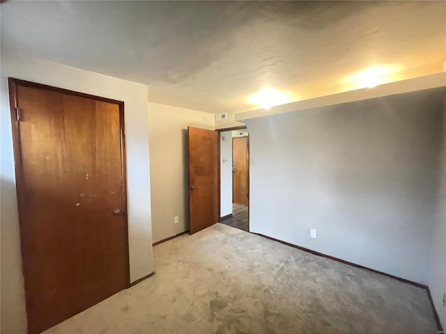 unfurnished bedroom featuring carpet and a closet