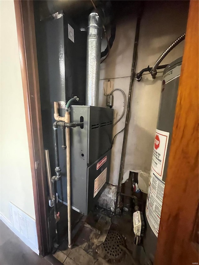 utility room featuring gas water heater