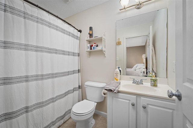 bathroom with vanity, tile patterned floors, a textured ceiling, and toilet