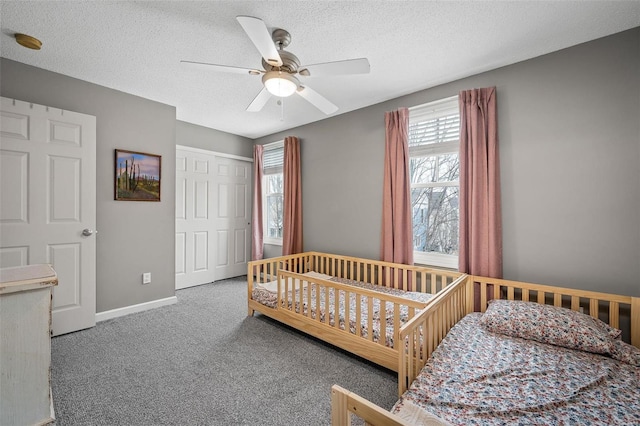 bedroom featuring ceiling fan, carpet, a textured ceiling, and a closet