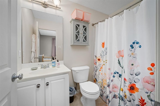 bathroom featuring tile patterned floors, toilet, a textured ceiling, vanity, and curtained shower