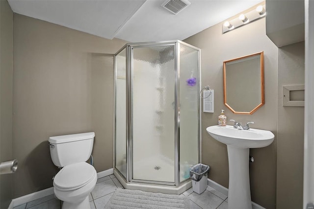 bathroom featuring a shower with door, sink, tile patterned floors, and toilet