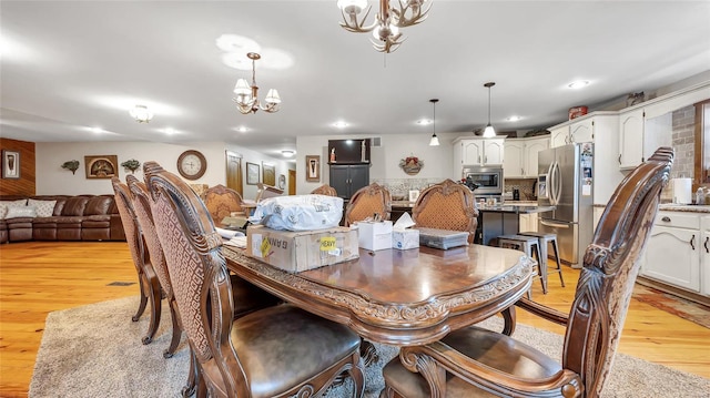 dining space featuring a chandelier and light hardwood / wood-style floors