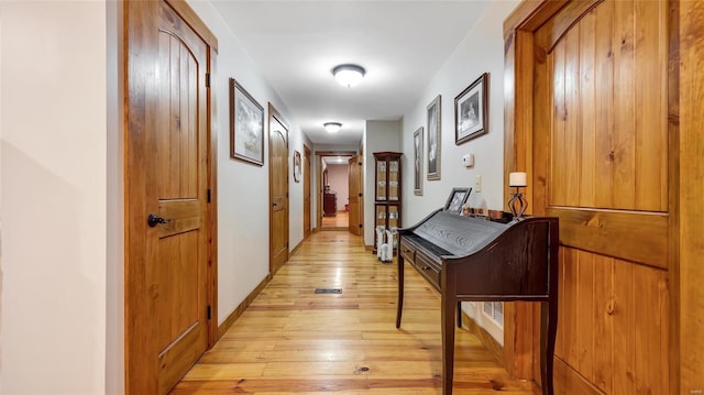 hall with light hardwood / wood-style flooring