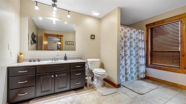 bathroom featuring ceiling fan, vanity, and toilet