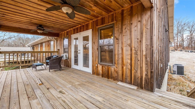 wooden deck with cooling unit, central air condition unit, ceiling fan, and french doors