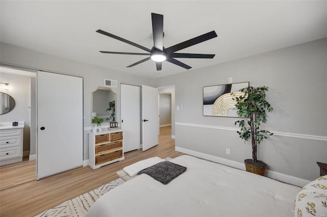 bedroom with light wood-type flooring, visible vents, ceiling fan, and baseboards