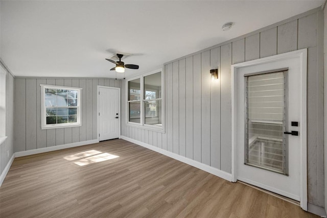 unfurnished sunroom featuring a ceiling fan