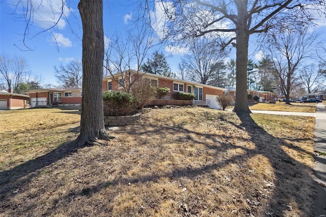 ranch-style house featuring a garage and brick siding