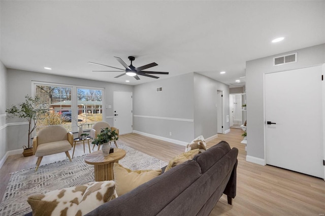 living room with baseboards, recessed lighting, visible vents, and light wood-style floors