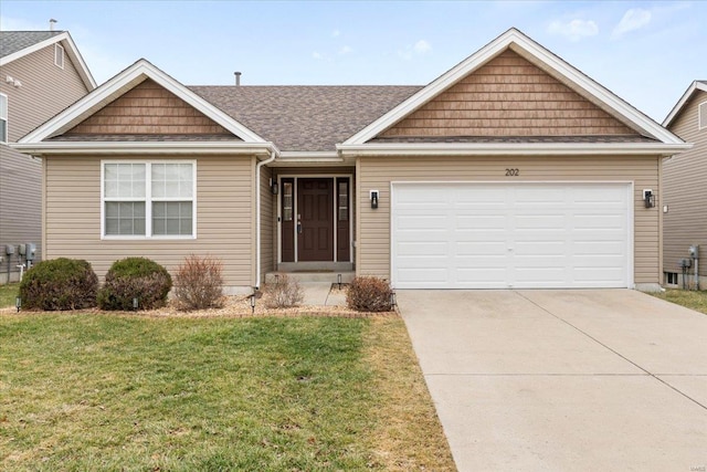 view of front of property with a garage and a front lawn