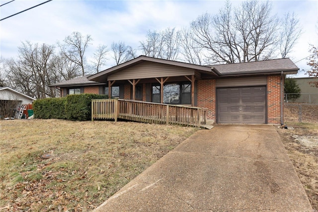 ranch-style home featuring a garage, a porch, and a front lawn