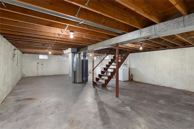 basement featuring washer / clothes dryer and water heater