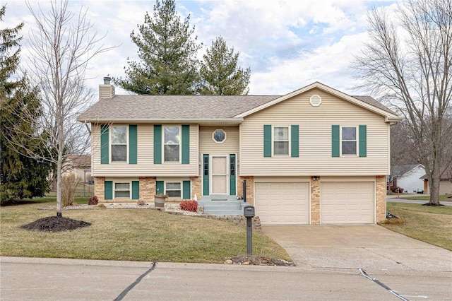 split foyer home featuring a garage and a front lawn