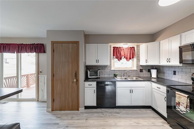 kitchen featuring sink, white cabinets, light hardwood / wood-style floors, and black appliances