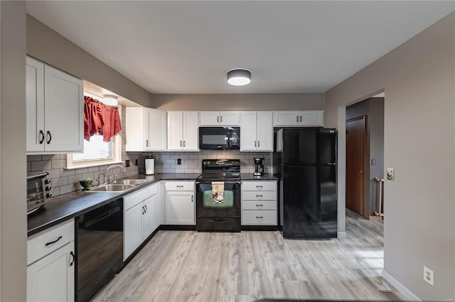 kitchen with white cabinets and black appliances